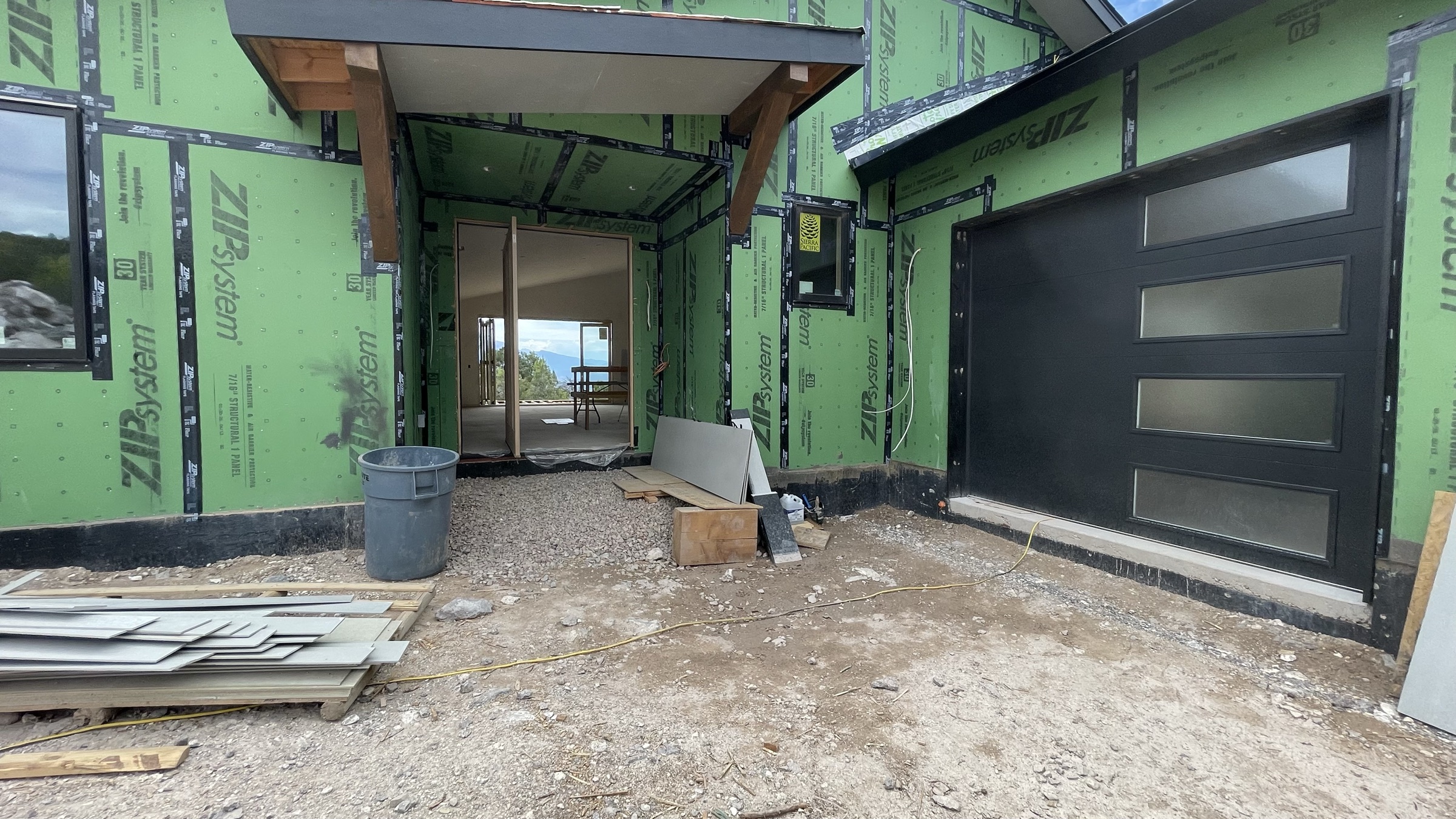 Entry approach with modern garage doors and covered porch — July 26, 2026