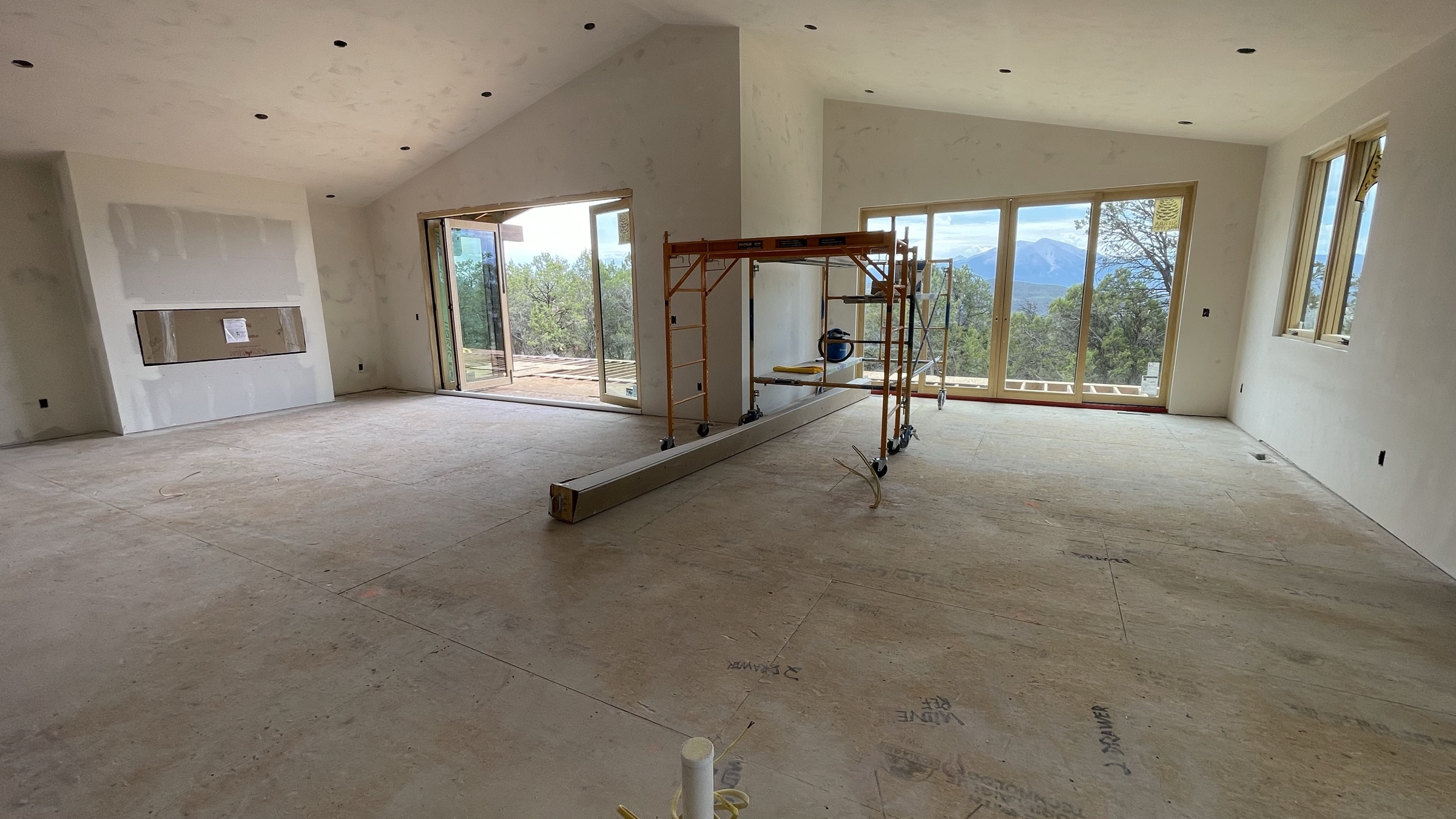 Main floor living area with media niche and dual view windows, drywall complete — July 26, 2026