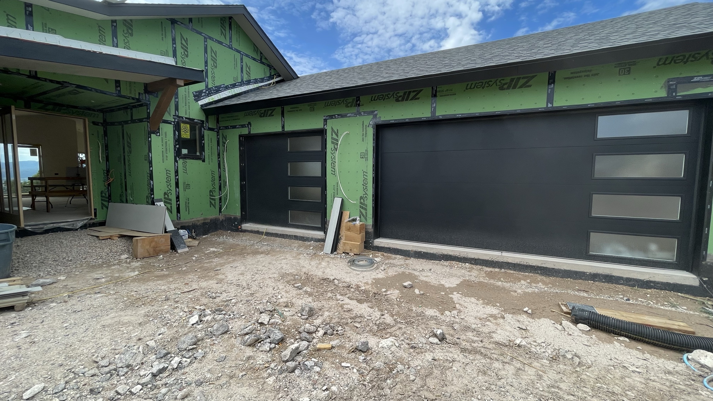 Modern black garage doors with frosted glass panels installed — July 26, 2026