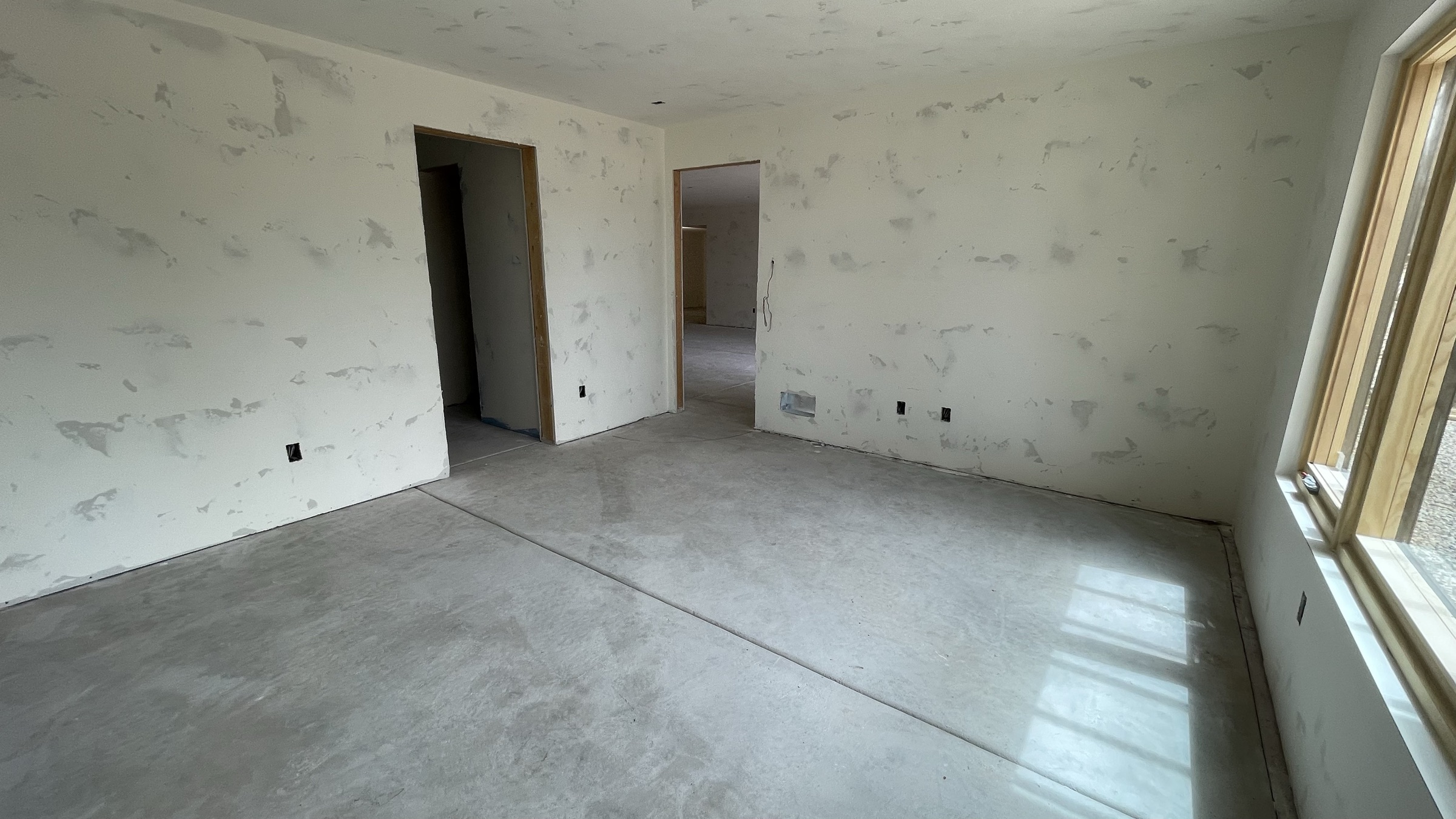 Guest master bedroom window framing the wooded hillside — July 26, 2026