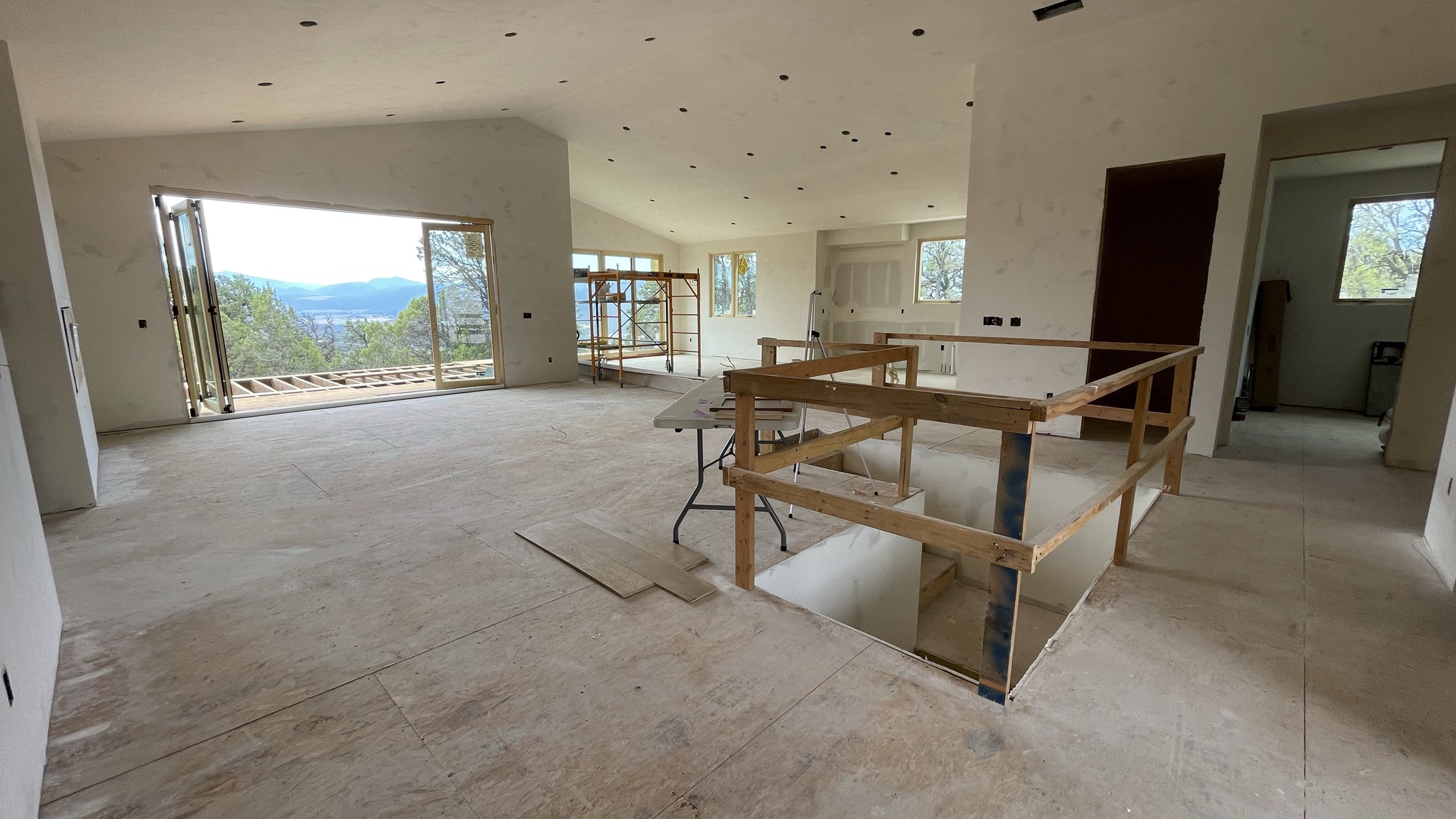 Open-concept main level from the kitchen with sliding doors open to the valley — July 26, 2026