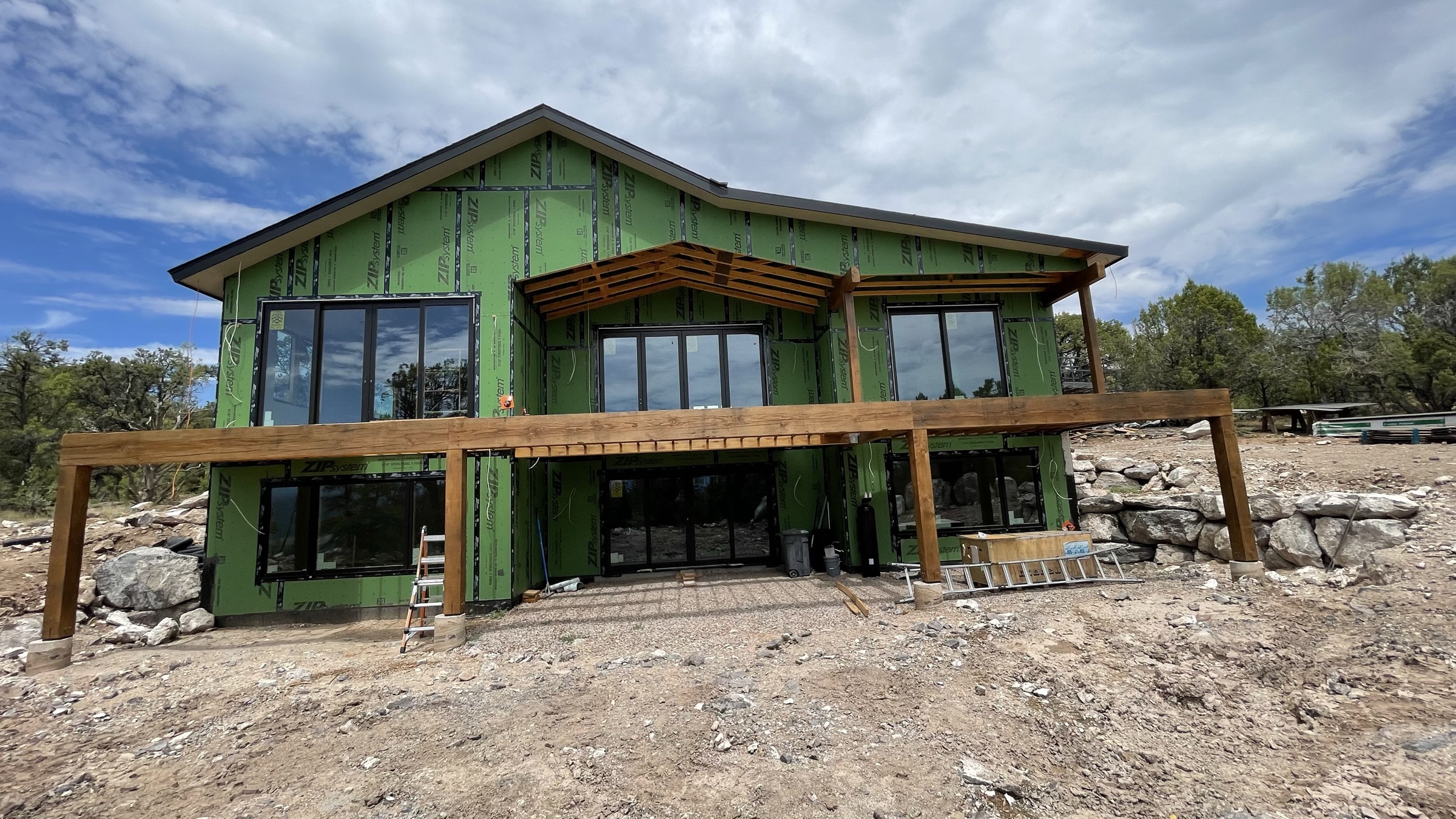 Rear corner elevation showing deck structure and window walls — July 26, 2026