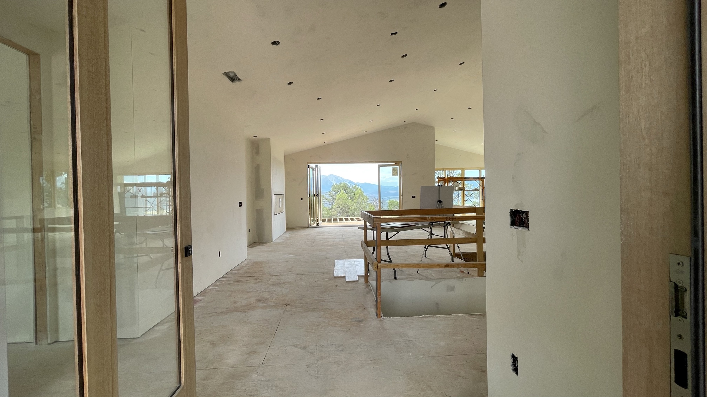 Vaulted great room ceiling with drywall complete and mountain views — July 26, 2026