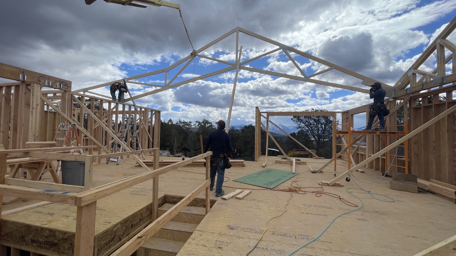Framing crew with mountain backdrop