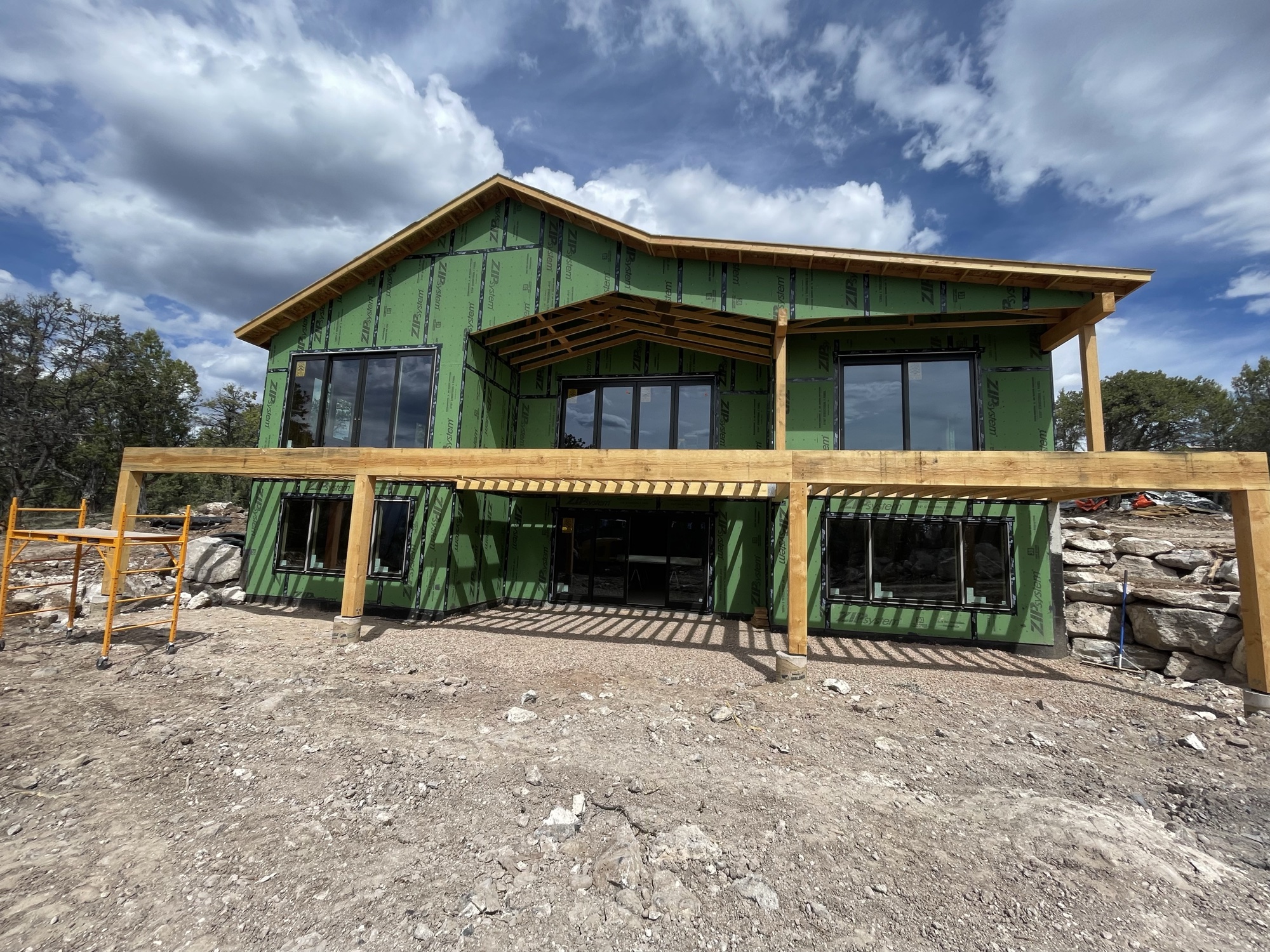 The Vista exterior — covered deck, vaulted rooflines, and walls of windows framing the Mt. Sopris view
