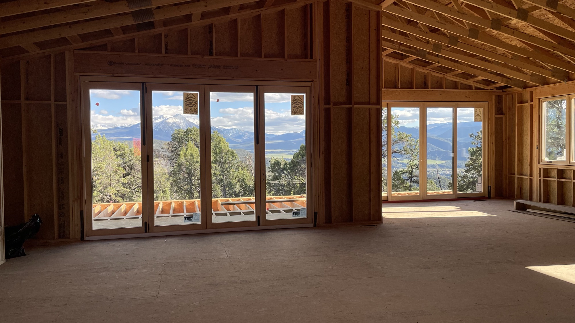 Great room interior with sliding-door walls framing Mt. Sopris and the Roaring Fork Valley