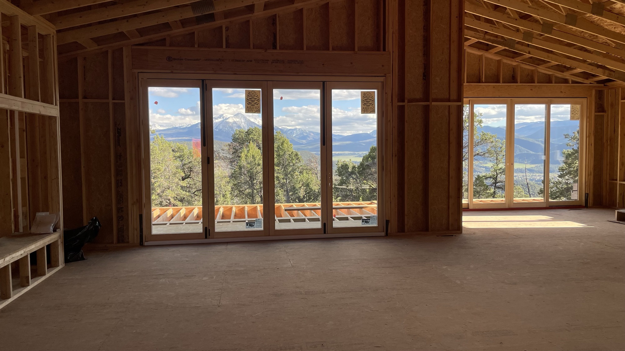 Great room interior from a second angle showing both window walls — April 15, 2026
